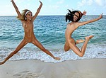 Nudist and naturist girls jumping nude on the beach and spreading legs in the air flashing their beautiful pussies