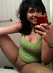 Cheerful latina girl with so sexy smile and big natural boobs is posing nude in front of the mirror, taking nude selfies and showing pussy close up, taking homemade porn photos of it on phone